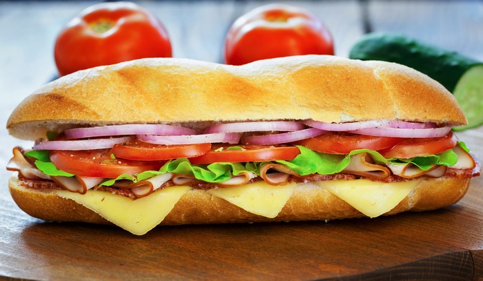 Submarine sandwich with turkey, cheese, tomatoes, and onions