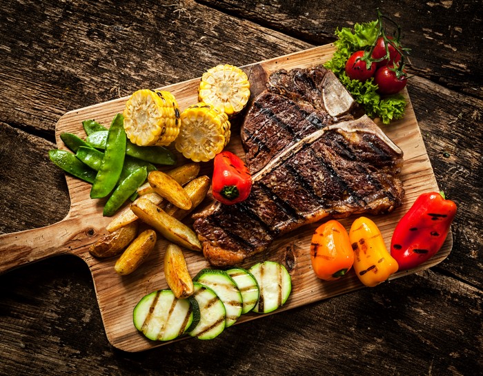 4K Grilled T-bone Steak with Vegetables on Cutting Board