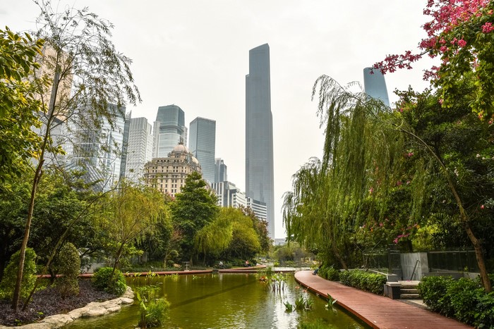 Park with pond and skyscrapers in Guangzhou, China