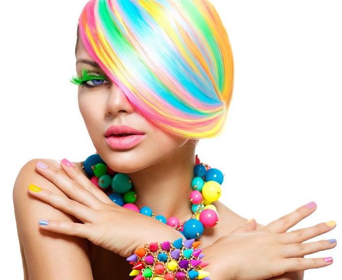 Woman with multicolor hair, makeup, and jewelry