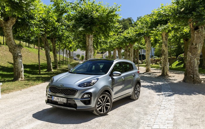Grey Kia Sportage parked on a gravel path