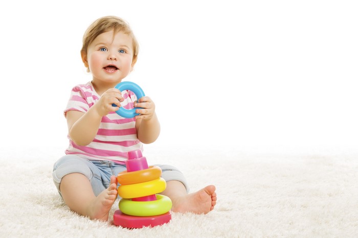 Baby playing with stacking rings toy