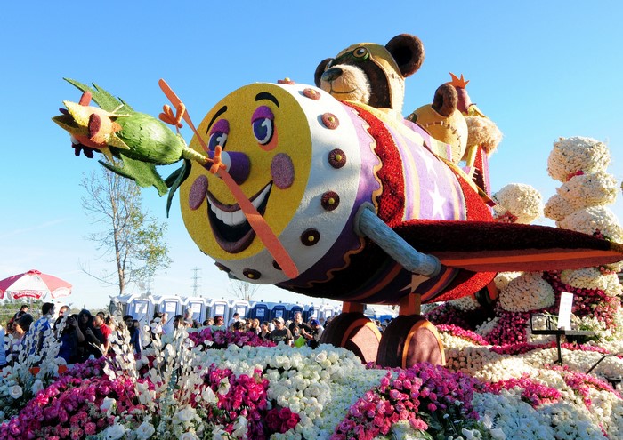 Flower float with airplane, bear, and bird