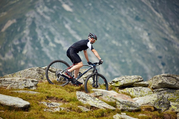Man riding a mountain bike on a rocky mountain trail