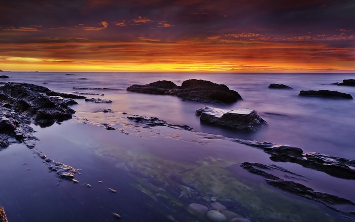 Sunset over the sea with rocks