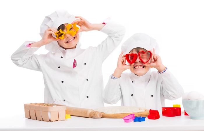 Two Boys in Chef Uniforms with Cookie Cutters