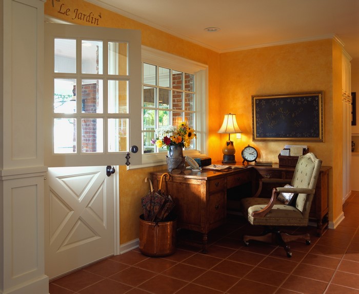 Home office with desk, chair, and door