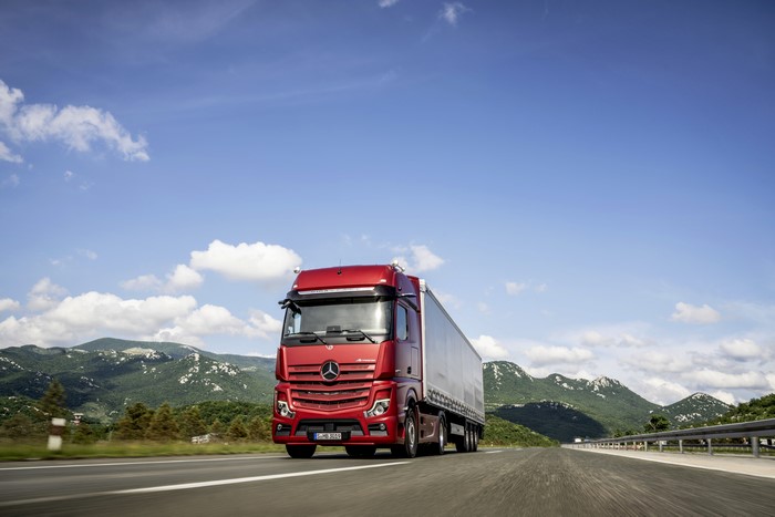 Red Mercedes-Benz 4x2 Actros Truck in Motion