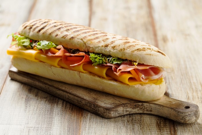 Sandwich with ham and cheese on a cutting board
