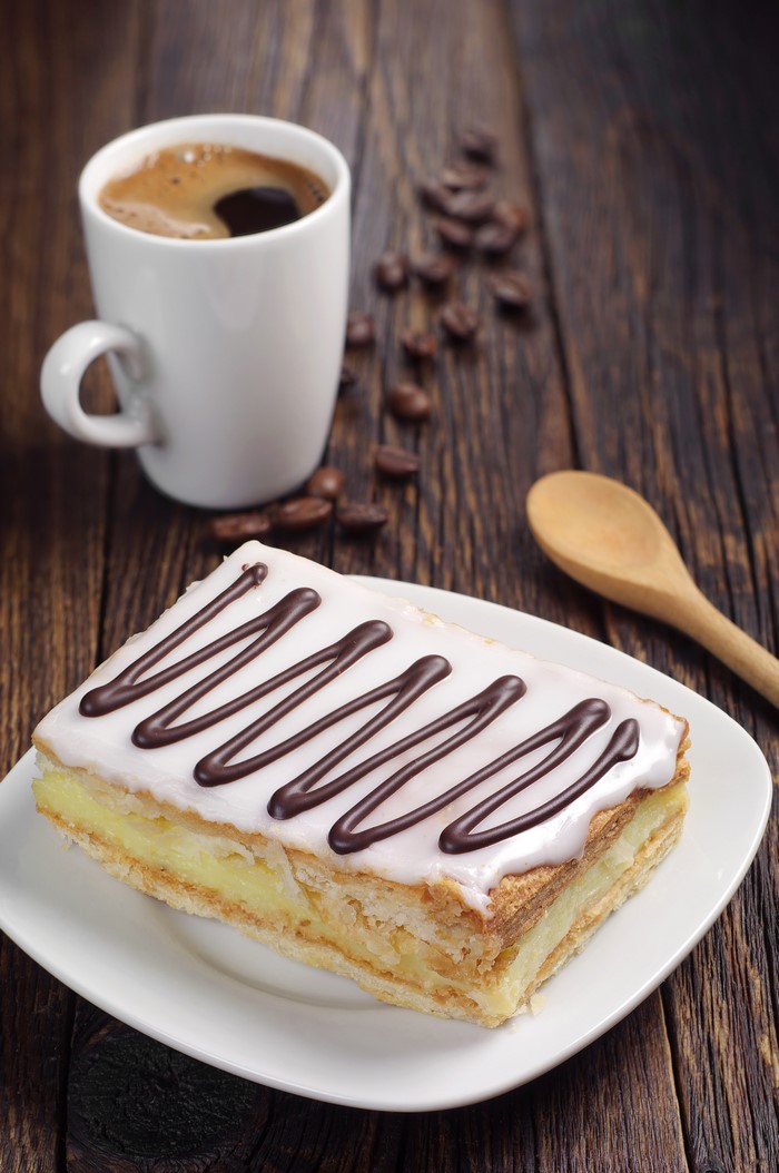 Slice of cake with coffee and coffee beans