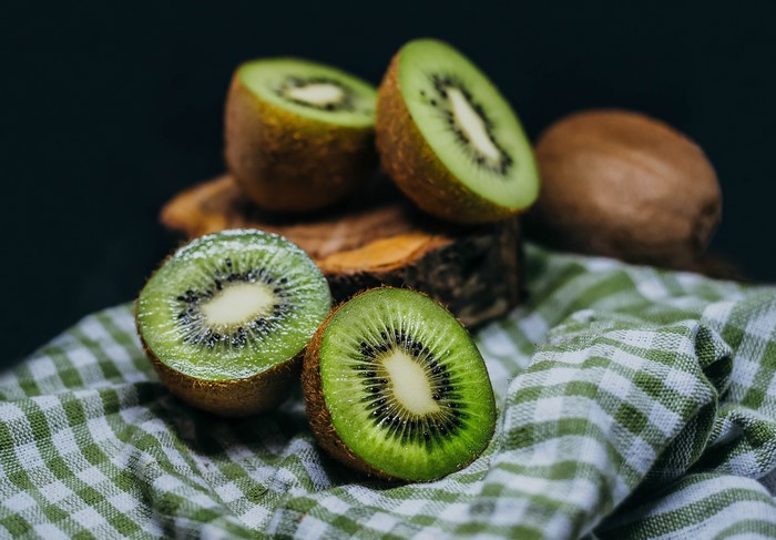 Kiwi fruit halves on a checkered cloth