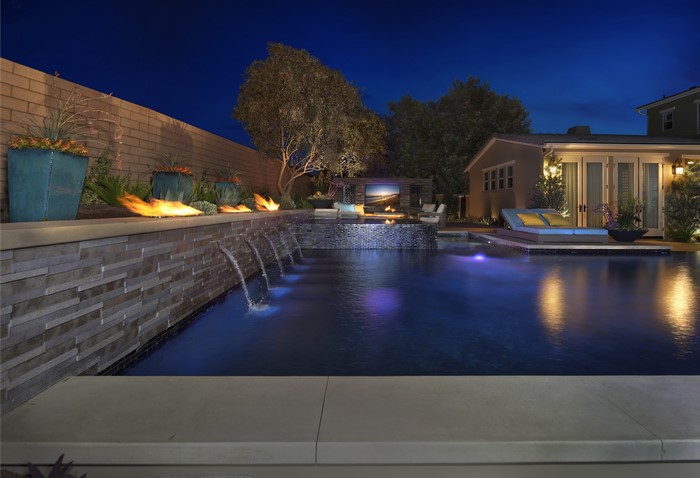 Luxury Backyard Pool with Fire Features and Entertainment Area at Night