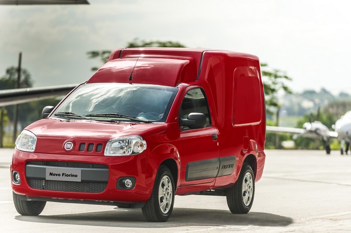 Red Fiat Fiorino Van on Tarmac with Airplanes