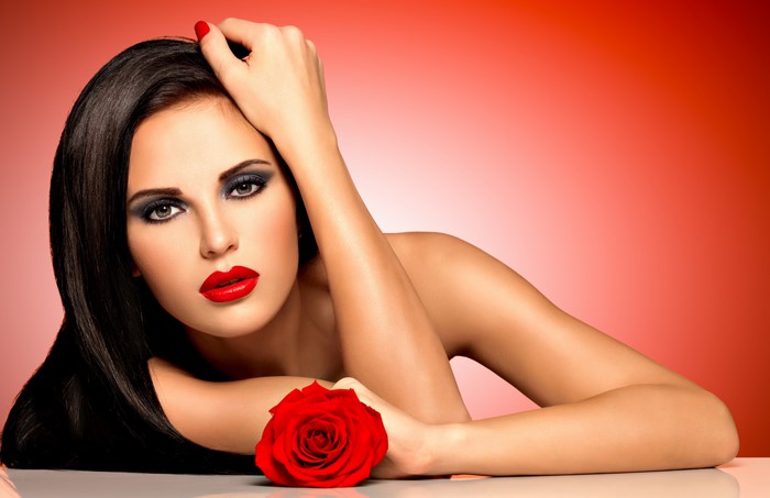 Woman with red lips and rose