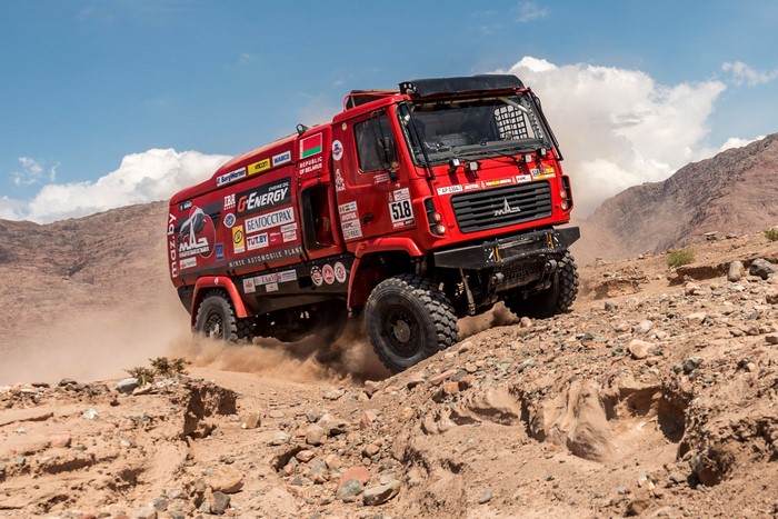 Red MAZ-5309RR rally truck driving on a dirt road
