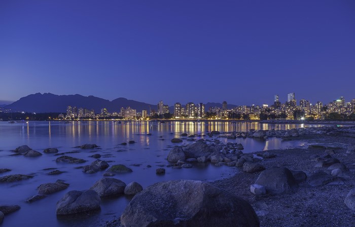 Vancouver Skyline at Dusk with Mountains and Rocky Shore