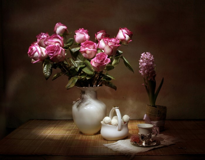 Still-life with roses, hyacinths, sweets, vase, and cup