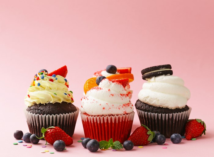 Cupcakes with Fruits and Sprinkles on Pink Background