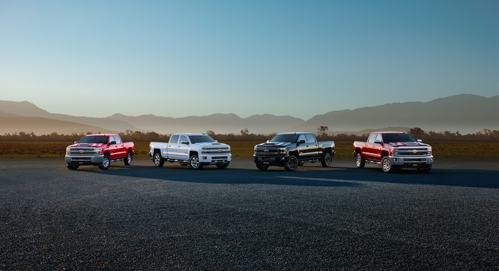 Four Chevrolet Pickup Trucks in a Landscape