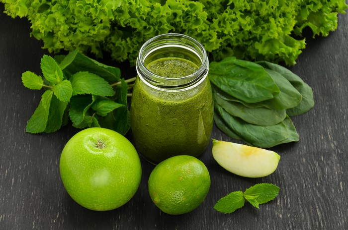 Green smoothie with apple, lime, mint, and lettuce