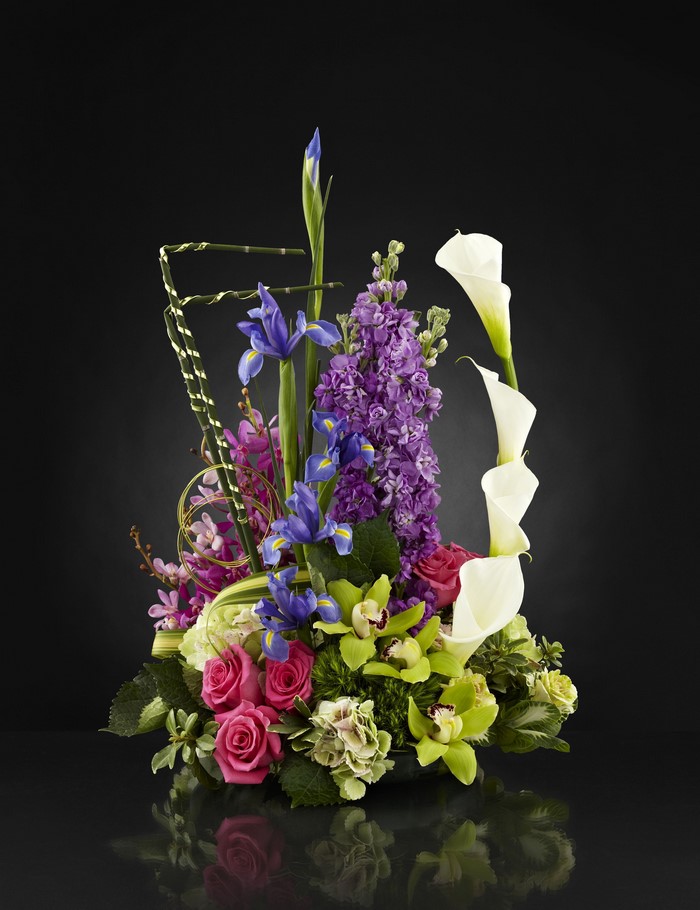 Floral arrangement with roses, orchids, callas, irises, and matthiola