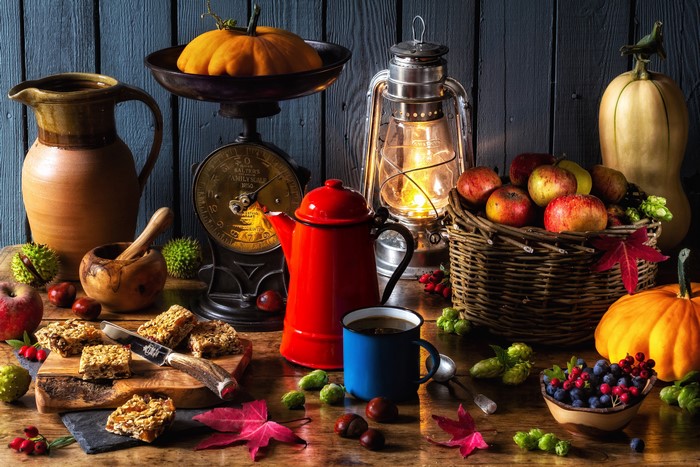 Autumn still life with pumpkin, apples, berries, and kettle