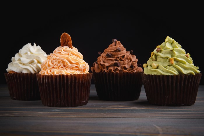 Four cupcakes with different frosting and toppings
