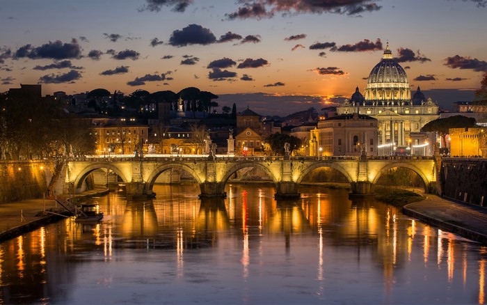 Ponte Sant'Angelo and St. Peter's Basilica at dusk in Rome