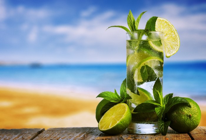 Mojito with limes and mint on a beach