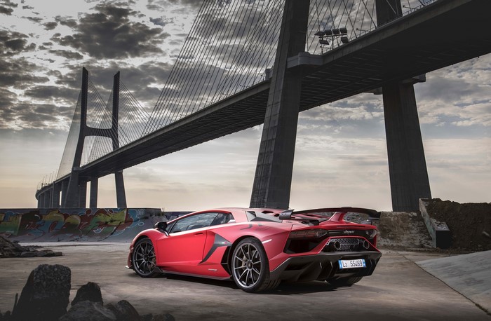 Red Lamborghini Aventador SVJ 2018 under a bridge