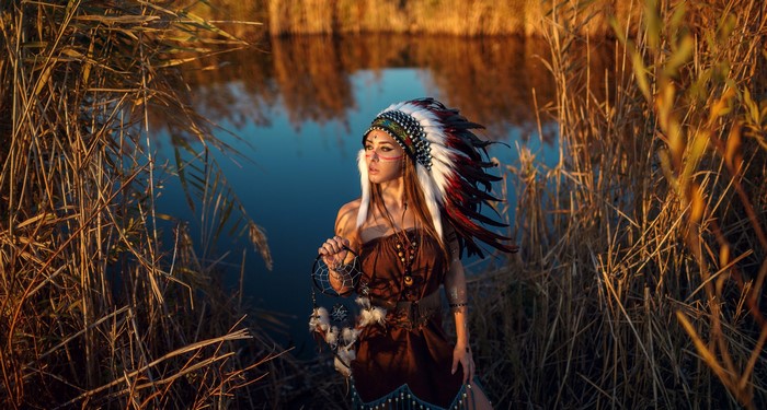 Woman in War Bonnet with Dreamcatcher by Water