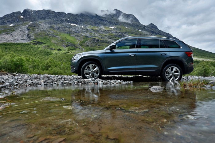 Skoda Kodiaq SUV on a rocky riverbed with mountains