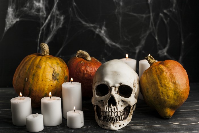 Halloween skull, pumpkins, and candles with spiderwebs