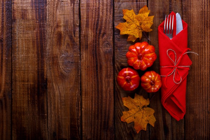 Thanksgiving Table Setting with Pumpkins and Maple Leaves