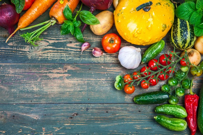 Assortment of fresh vegetables on a wooden table