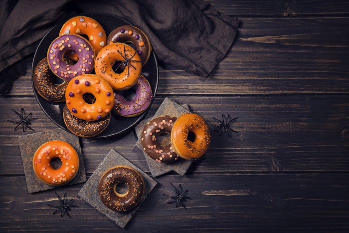 Halloween donuts with spiders on wooden planks