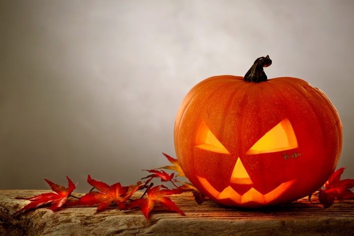 Halloween pumpkin with autumn leaves