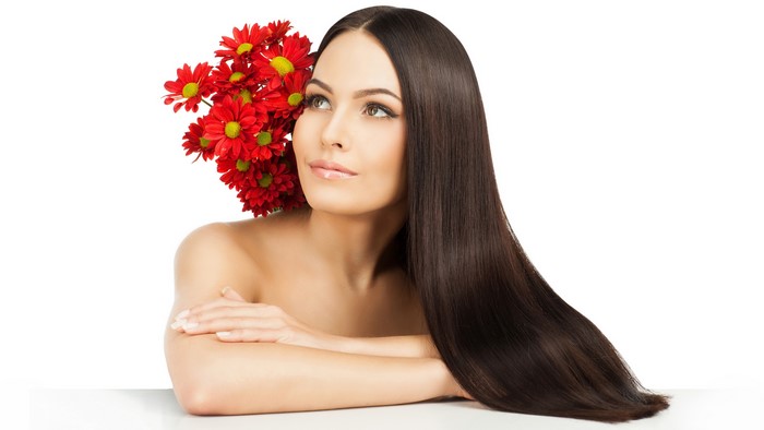 Woman with brown hair and red chrysanthemums