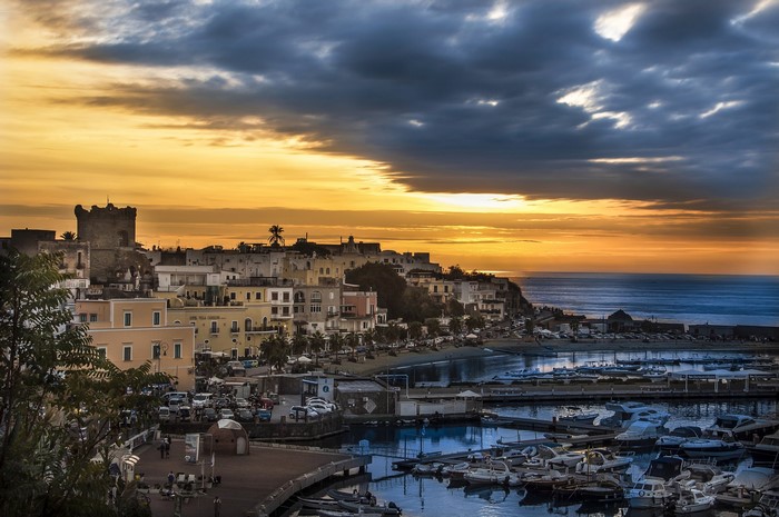 Forio, Italy harbor at sunset with castle