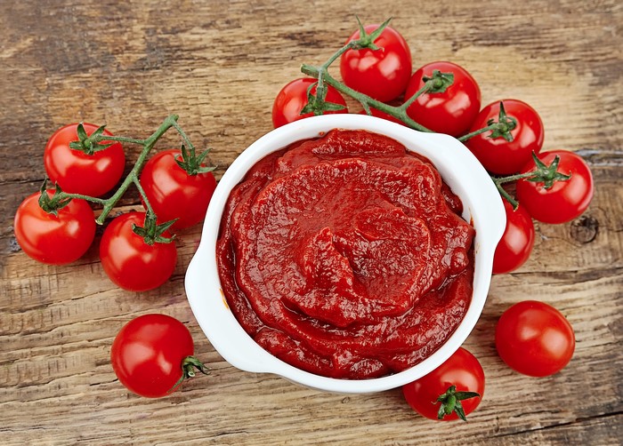 Tomatoes and Ketchup on Wood Planks