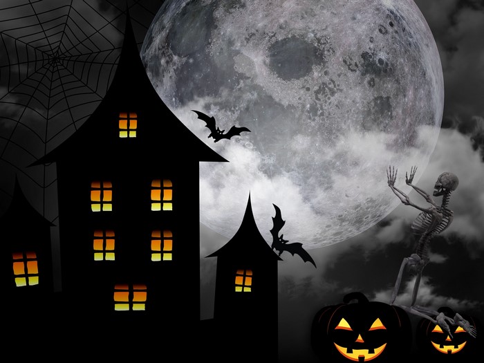 Halloween scene with haunted houses, moon, and skeleton