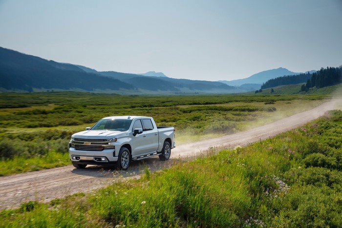 White Chevrolet Silverado High Country Crew Cab on dirt road
