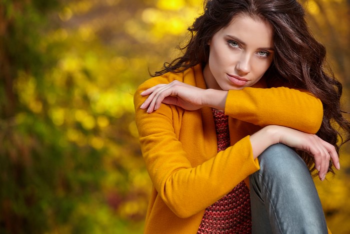 Woman with brown hair in yellow jacket