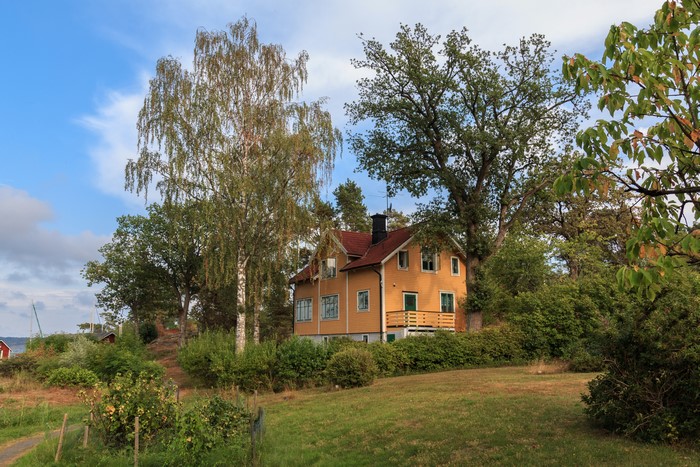 Yellow house in Saltsjobaden, Sweden with trees