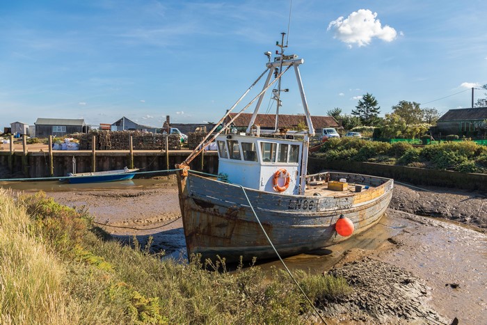 Fishing boat moored in Brancaster Staithe, England