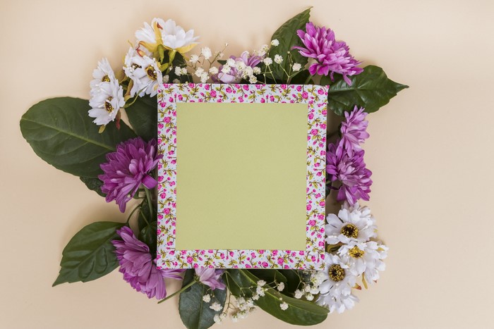 Chrysanthemums and white flowers around a template greeting card