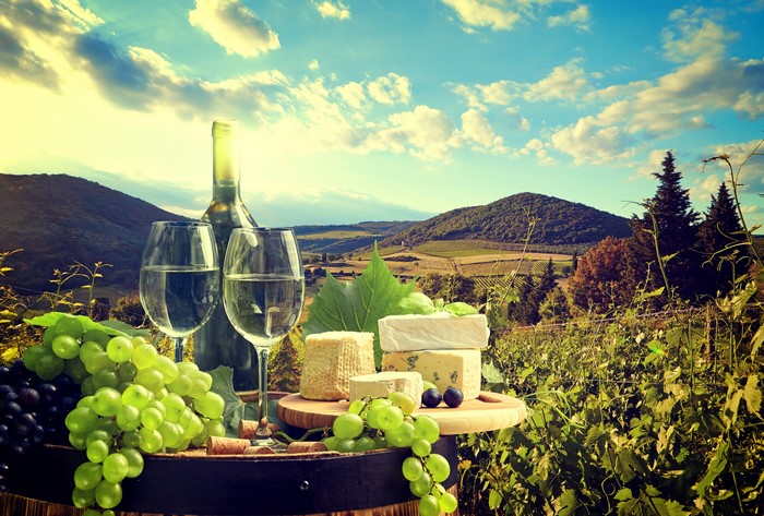 Still-life of Wine, Grapes, and Cheese in a Vineyard