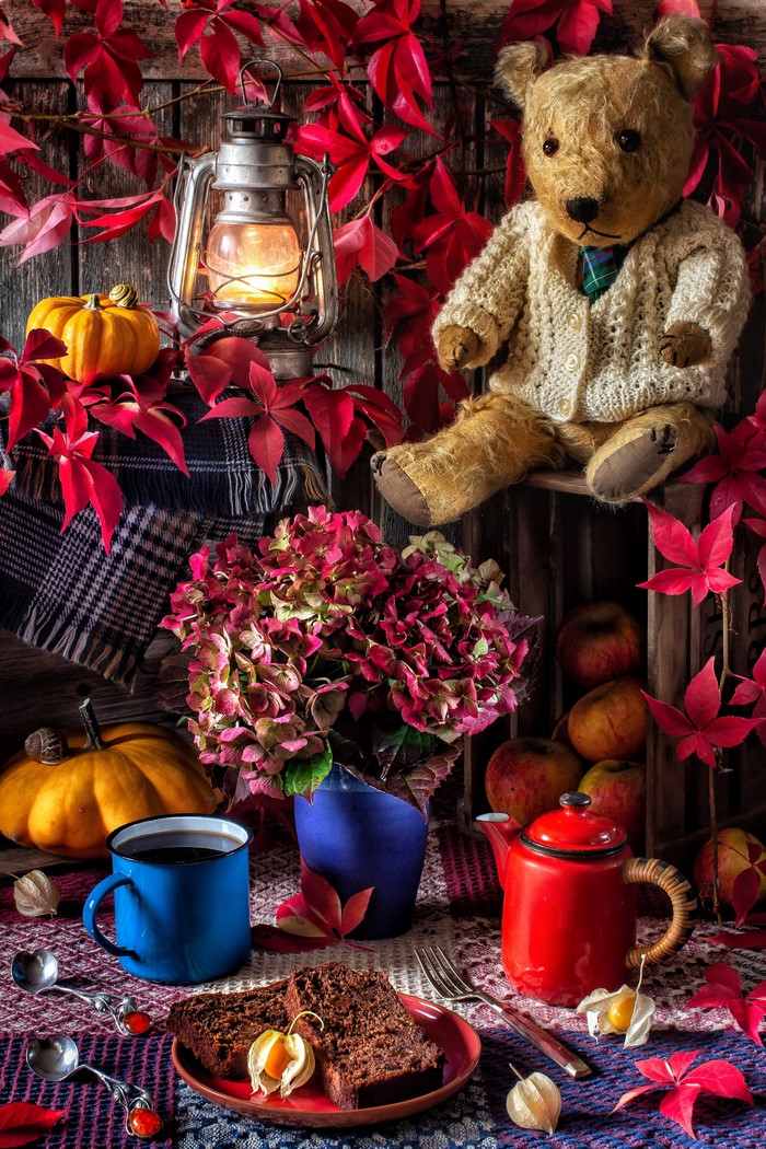 Autumn still-life with teddy bear, lantern, and cake