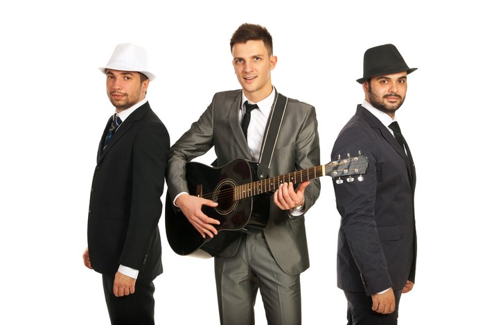 Three Men in Suits with Guitar on White Background