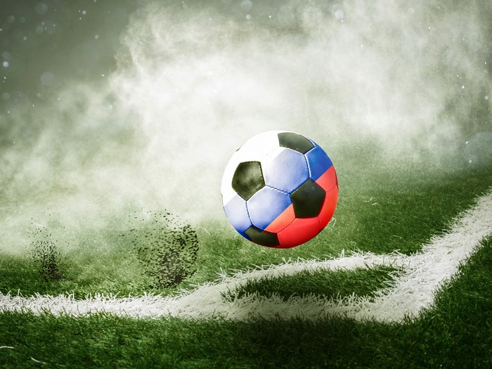 Soccer ball with Russian flag colors on a grassy field